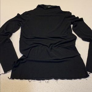 Tight fitting and light black turtleneck by COS
